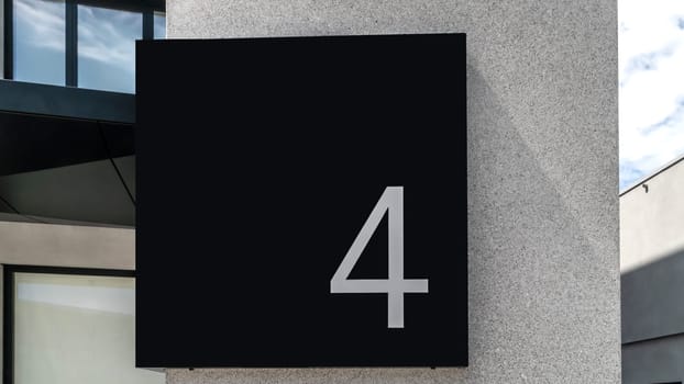 Number Four with black background on a facade
