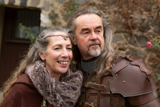 Couple posing robed in beautiful medieval clothing