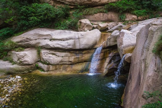 Small pond and waterfall under the Hua shan mountain, famous tourist attraction, Shaanxi province, China