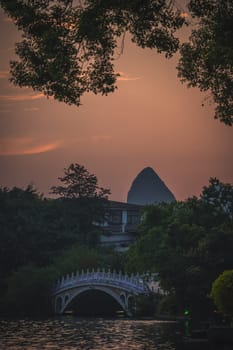 Beautiful sunset over the marble bridge on Shan Lake, Guilin town, Guangxi Province, China