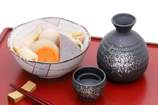 Japanese traditional sake cup and bottle with oden on tray