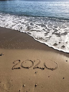 2020 sign written in sand