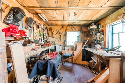 Russia, Moscow- July 08, 2019: interior room apartment. DIY in garage workshop. old machinery repair and production equipment.