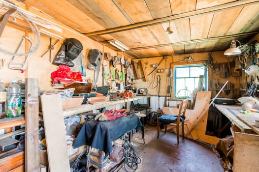 Russia, Moscow- July 08, 2019: interior room apartment. DIY in garage workshop. old machinery repair and production equipment.