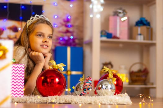 Beautiful ten-year-old girl lies on a rug in the New Year’s interior