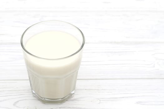 Glass of tonyu milk on wooden white table
