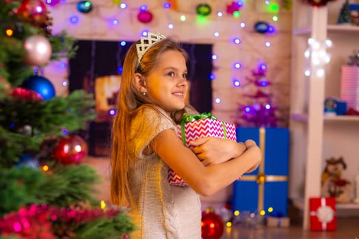 Beautiful ten-year-old girl hugged a gift