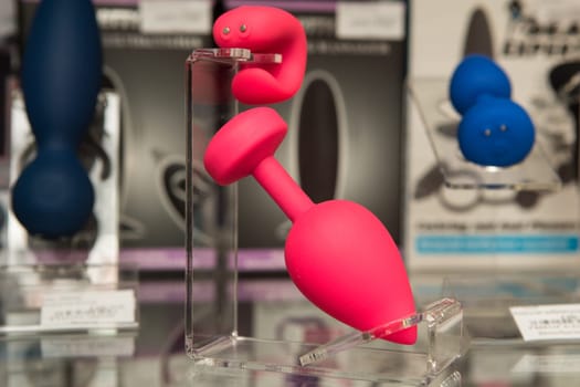 sex toys on a glass display in the store