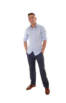A handsome young east Indian man standing in a blue shirt with his.hands in his pocket, smiling, isolated for white background.