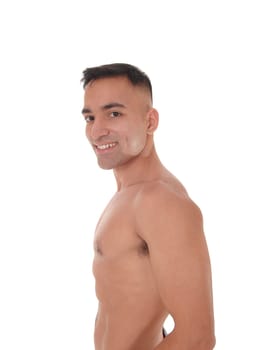 A handsome young east Indian man standing shirtless and smiling.looking into the camera, isolated for white background.
