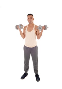 A east Indian man working out with two dumbbells in his.track pants, isolated for white background.