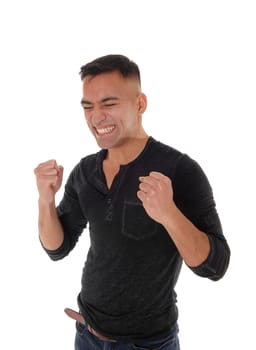 A handsome young man is happy he got what he wants by making.fist's with booths hands and eyes closed, isolated for white background.