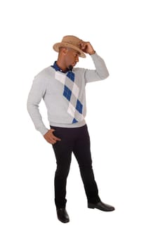 A handsome young African American man standing with his thumps.up in a sweater and cowboy hat, isolated for white background.
