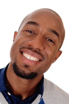 An close up portrait image of an African American man smiling bald.and with a small beard, isolated for white background.