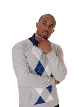 A young handsome African American man standing waist up in the.studio with one hand on neck, thinking, isolated for white background.