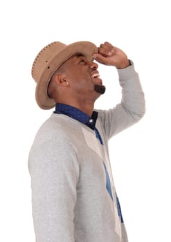 A closeup image of a very happy young African American man with .his hands behind his head wearing a hat, isolated for white background.
