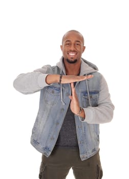 A handsome young African American man standing halve length in a .jeans jacket and signing to talk, isolated for white background.