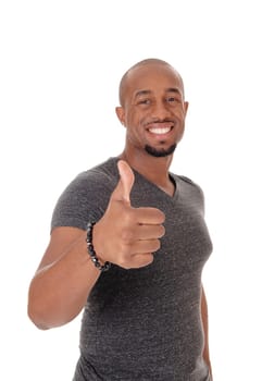 A smiling African American man standing in a sweater pointing with his.thump to the other person, isolated for white background.