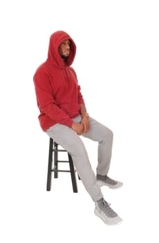 A close up image of an African American young man wearing a burgundy.hoody with a beard, isolated for white background.