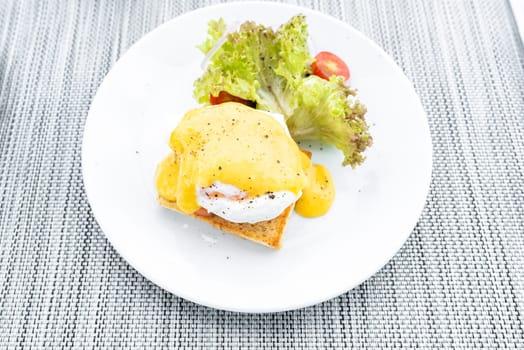 gourmet Salmon egg benedict in white plate