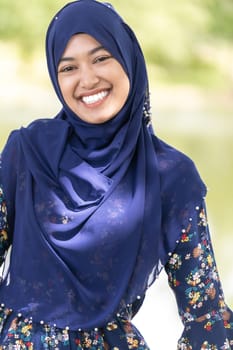 Portrait of good-looking Happy young teenager Muslim islamic asian university girl