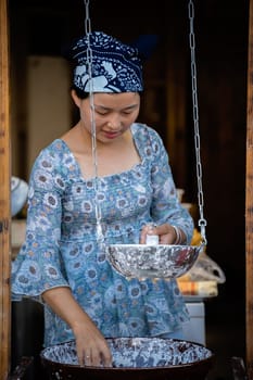 Feng Huang, China -  August 2019 : Woman making traditional chinese noodles on the food stall in Feng Huang old town