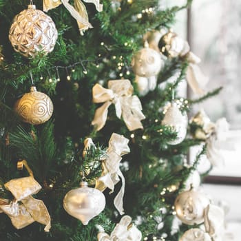 Vintage Christmas tree with ornaments. Defocused blurry background. Close-up.