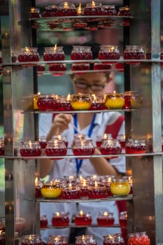 Chengdu, China -  July 2019 : Chinese man lightening up the memorial candle in the Wenshu Monastery