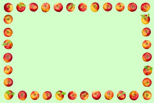 Frame of apples isolated on a green background. With apple leaves.