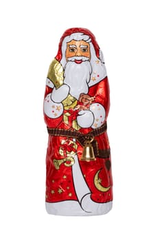 Chocolate Santa isolated. Close-up of a cheerful wrapped chocolate Santa Claus or the good Saint Nicolas figurine isolated on a white background. Macro photograph.