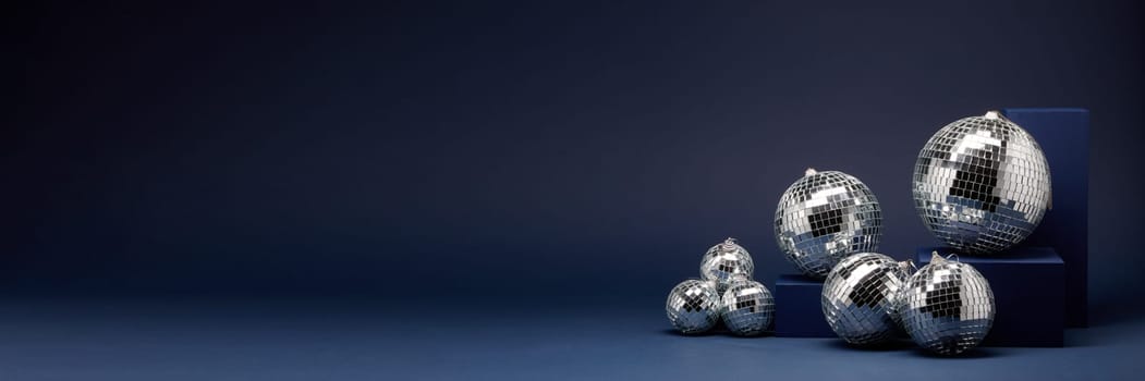 Abstract composition with blue geometrical figures and mirorr balls on dark blue background with copy space. For design of advertising, web design. Christmas and New Year