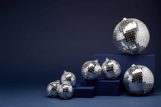 Abstract composition with blue geometrical figures and mirorr balls on dark blue background with copy space. For design of advertising, web design. Christmas and New Year