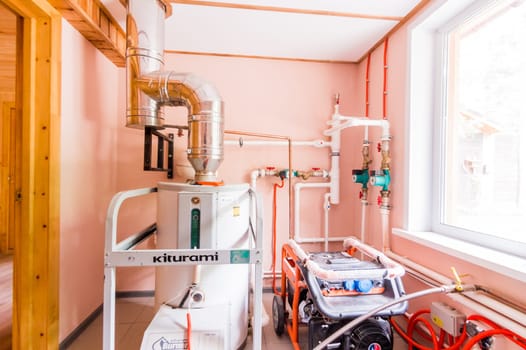 Russia, Moscow- July 23, 2019: interior room apartment. boiler room. heating system, pipes and appliances. kiturami