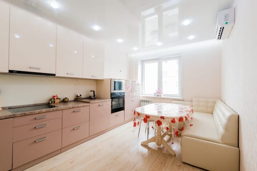 Russia, Moscow- July 23, 2019: interior room apartment. standard repair decoration in hostel. modern kitchen, dining area