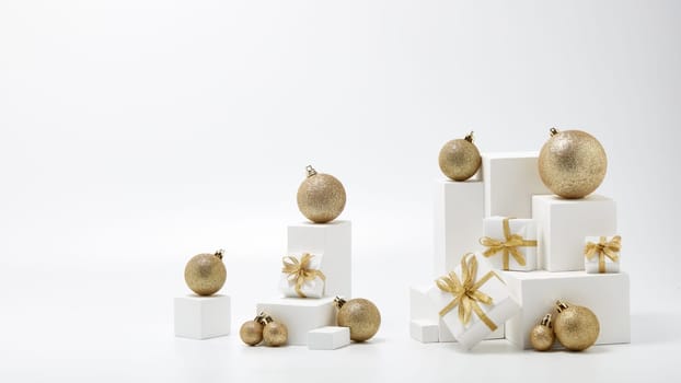 Festive composition with white geometrical figures, Christmas decorations and gift boxes isolated on white background with copy space. For design of advertising, web design. Christmas and New Year
