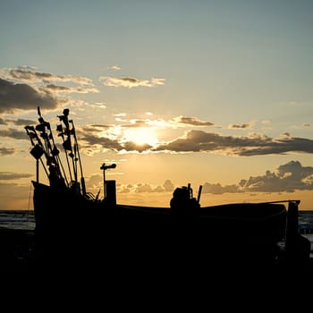 Fishing boat on the beach of the Polish Baltic Sea coast near Rewal at dusk
