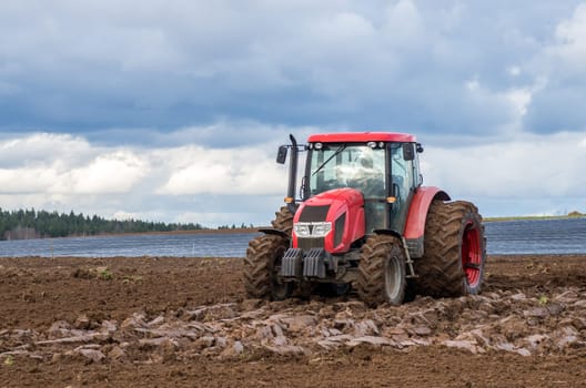 The tractor working on the large field