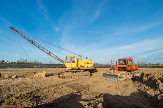 Tractor and excavator stay in the after hard work