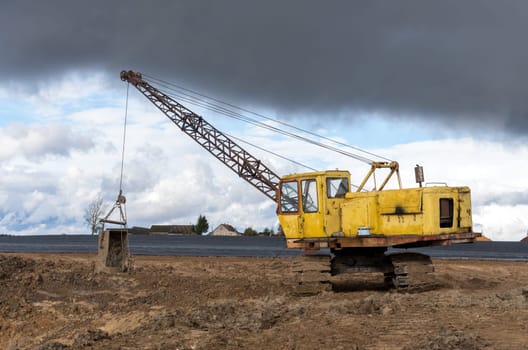 The old excavator stay in the field after works