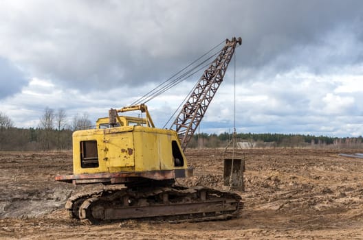 The old excavator stay in the field after works