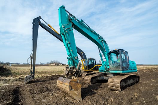 Two excavators stay after the hard work.