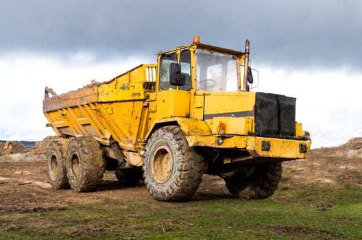 The big dump truck stay on the field.