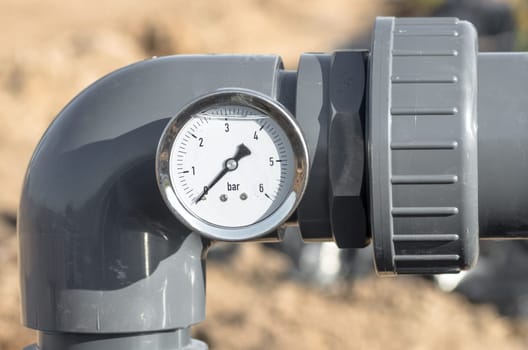 Close up of pressure gauge and pipes.
