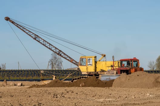 Tractor and excavator stay in the after hard work