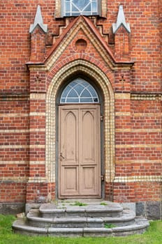 The old doors and stairs in the red brick wall.