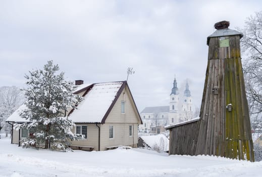 Winter landscape with village church and houses