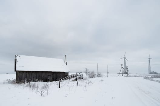 Winter landscape of fields and old farmstead