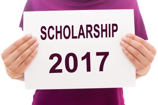 Girl holding white paper sheet with text SCHOLARSHIP 2017