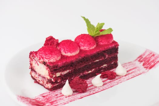 Plate with piece of delicious red velvet cake on white background