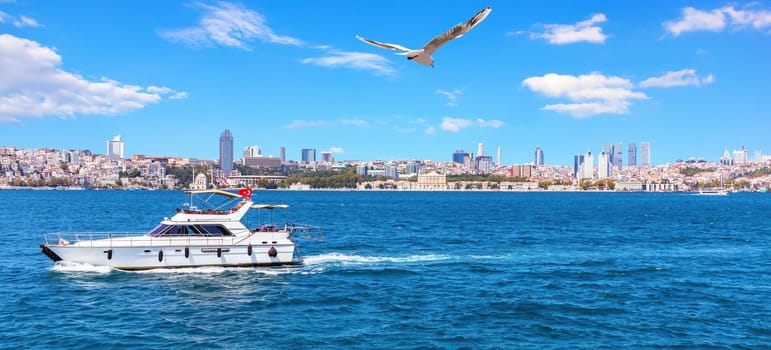 Yacht in the Bosporus and Besiktas view, Istanbul.